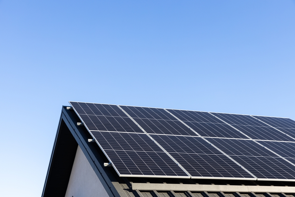 blue sky and top of roof with solar panels